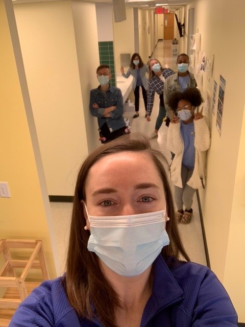 Staff posing for picture with masks on