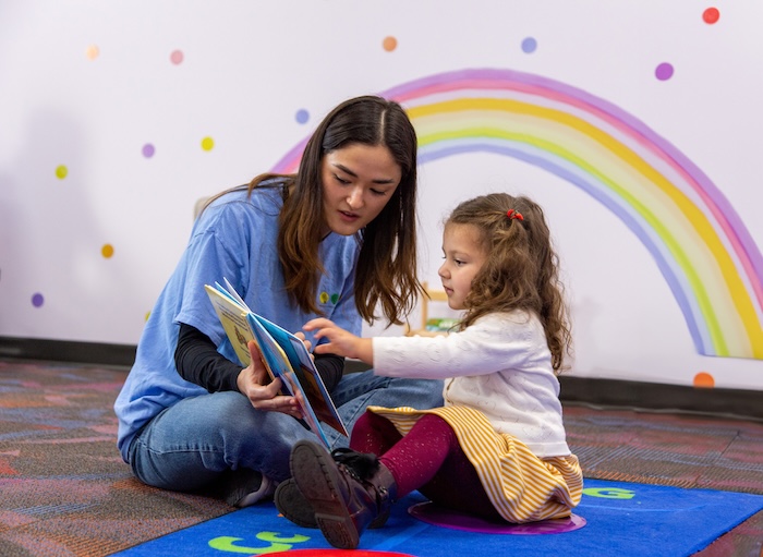 Teacher reading with student